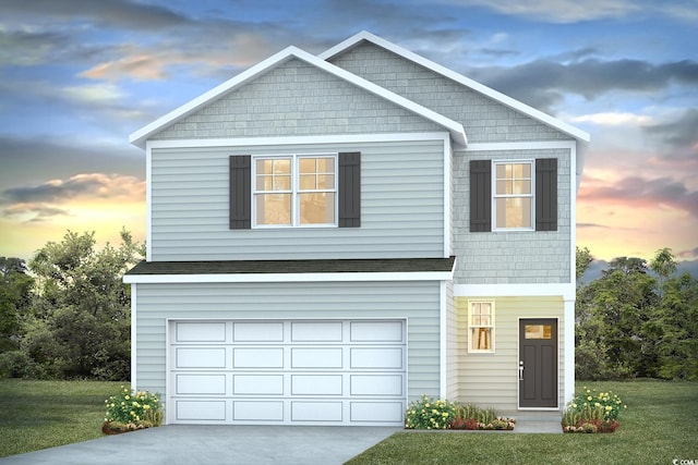 view of front facade with an attached garage, concrete driveway, and a yard