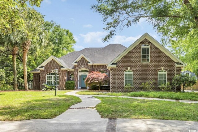 1203 Crooked Oak Dr, Pawleys Island, SC 29585 - view of front of house with brick siding and a front yard