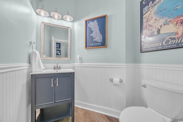 1203 Crooked Oak Dr, Pawleys Island, SC 29585 - bathroom with a wainscoted wall, toilet, wood finished floors, and vanity
