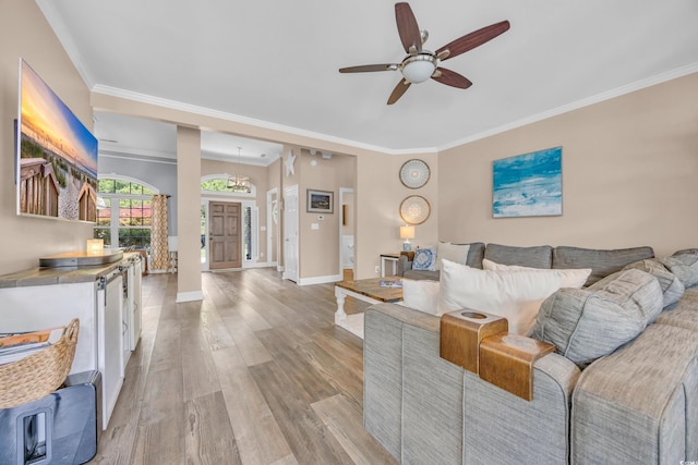 1203 Crooked Oak Dr, Pawleys Island, SC 29585 - living room with crown molding, light wood-style flooring, baseboards, and ceiling fan