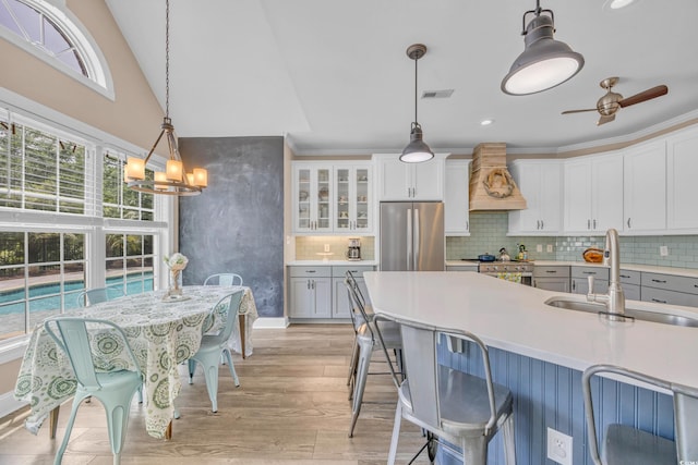 1203 Crooked Oak Dr, Pawleys Island, SC 29585 - kitchen with a sink, freestanding refrigerator, visible vents, light wood finished floors, and custom range hood