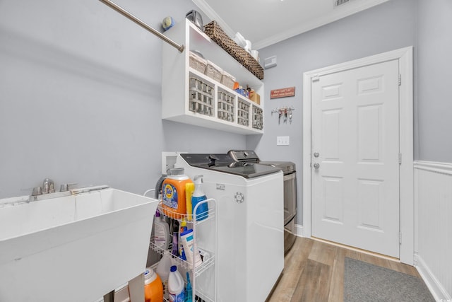 1203 Crooked Oak Dr, Pawleys Island, SC 29585 - washroom with a sink, wood finished floors, laundry area, crown molding, and separate washer and dryer