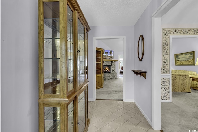 552 Enoree Ct, Myrtle Beach, SC 29588 - hall with light tile patterned floors, light carpet, baseboards, and a textured ceiling