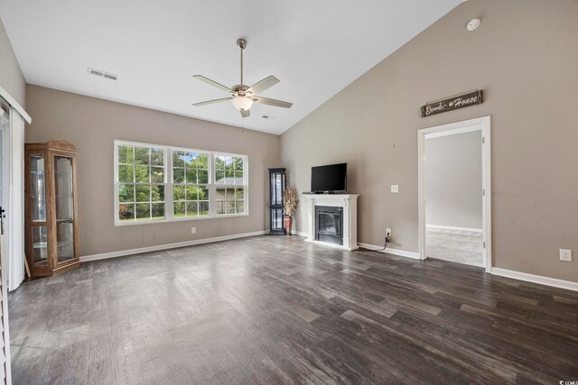 103 Teal Ct, Myrtle Beach, SC 29588 - unfurnished living room featuring ceiling fan, dark wood finished floors, a glass covered fireplace, high vaulted ceiling, and baseboards
