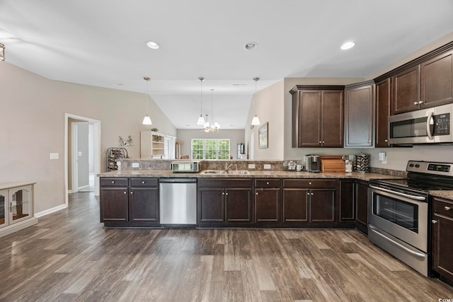 103 Teal Ct, Myrtle Beach, SC 29588 - kitchen with appliances with stainless steel finishes, vaulted ceiling, dark wood-style floors, dark brown cabinets, and a chandelier