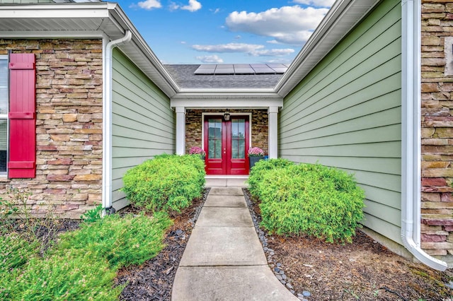 1286 Culbertson Ave, Myrtle Beach, SC 29577 - view of exterior entry featuring solar panels, french doors, and a shingled roof