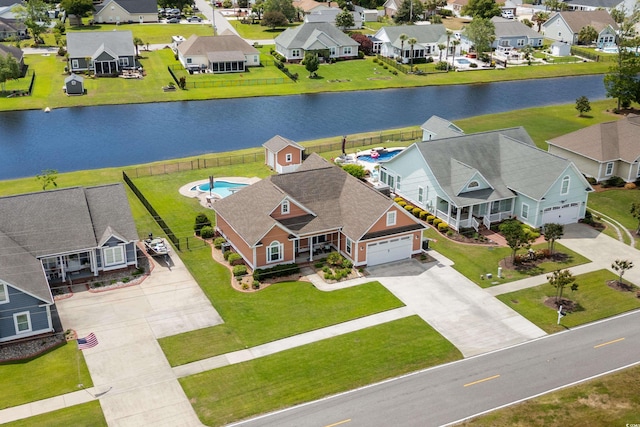 birds eye view of property with a water view and a residential view