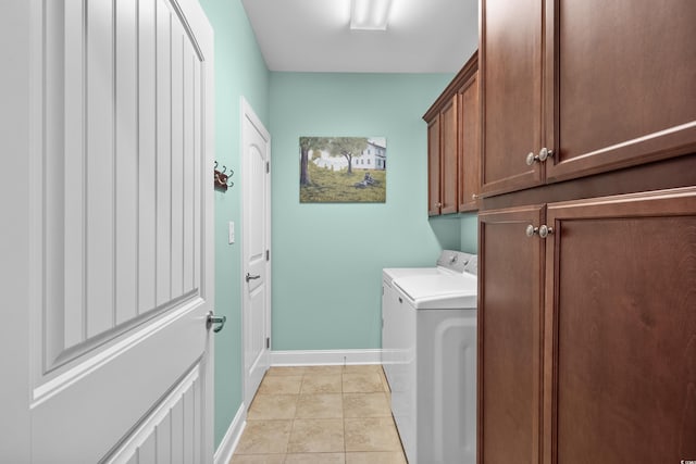 laundry room with separate washer and dryer, cabinet space, baseboards, and light tile patterned floors