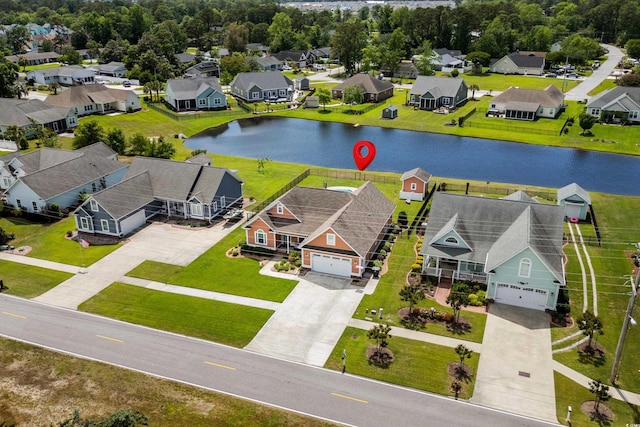 birds eye view of property featuring a water view and a residential view