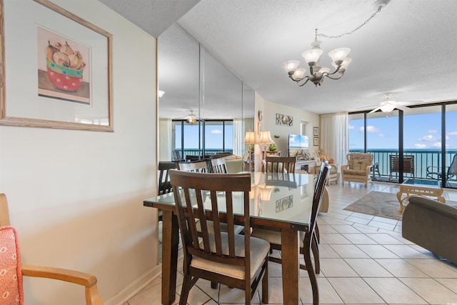 dining room with a chandelier, floor to ceiling windows, light tile patterned flooring, and a textured ceiling