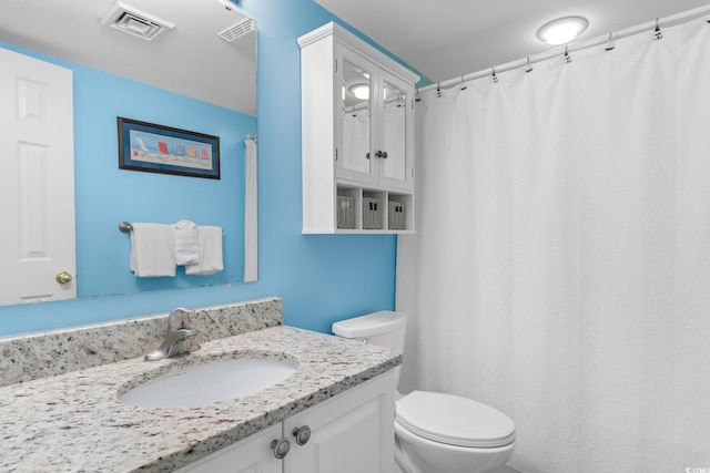 full bathroom with toilet and vanity