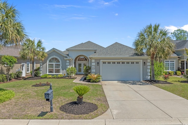 view of front of property with stucco siding, french doors, an attached garage, a front yard, and driveway