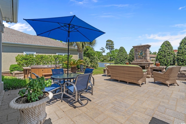 view of patio featuring a hot tub, an outdoor living space with a fireplace, and outdoor dining area