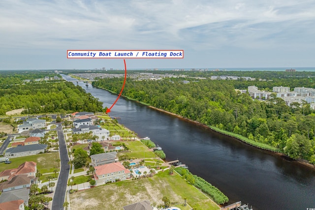 aerial view of property and surrounding area with a nearby body of water