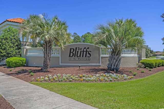 community sign featuring a lawn