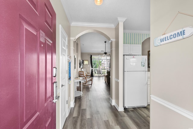 5751 Oyster Catcher Dr Unit 334, North Myrtle Beach, SC 29582 - entryway featuring dark wood-style flooring, arched walkways, a ceiling fan, and crown molding