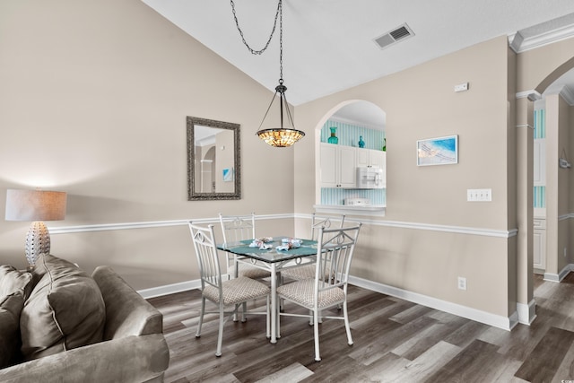 5751 Oyster Catcher Dr Unit 334, North Myrtle Beach, SC 29582 - dining room featuring arched walkways, wood finished floors, and lofted ceiling