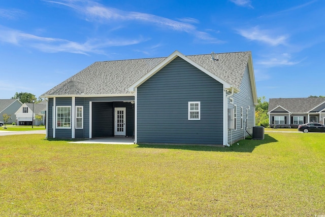 383 Hayloft Cir, Conway, SC 29526 - rear view of house with a patio area, central AC unit, a yard, and a shingled roof