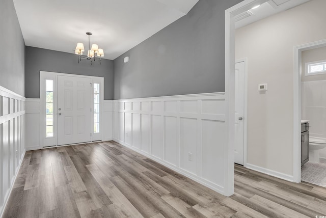 383 Hayloft Cir, Conway, SC 29526 - entrance foyer featuring a decorative wall, wood finished floors, a chandelier, and wainscoting