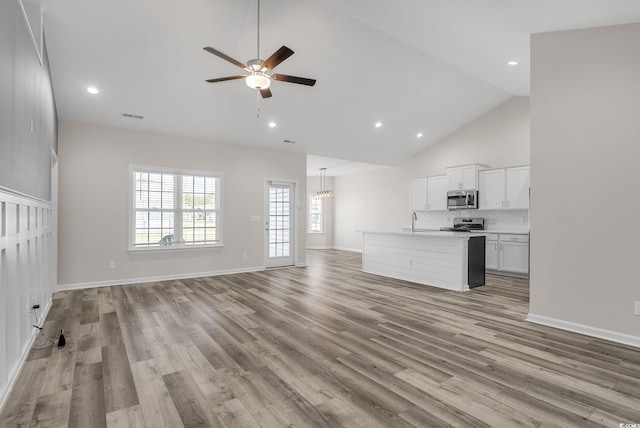 383 Hayloft Cir, Conway, SC 29526 - unfurnished living room featuring a sink, a ceiling fan, light wood-style flooring, high vaulted ceiling, and recessed lighting