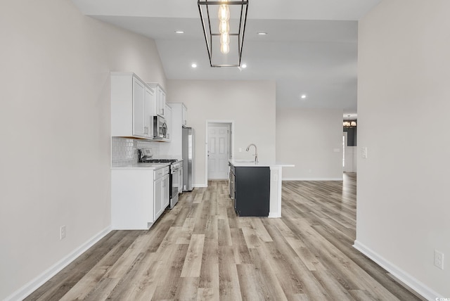383 Hayloft Cir, Conway, SC 29526 - kitchen featuring appliances with stainless steel finishes, light countertops, white cabinetry, light wood-style floors, and recessed lighting
