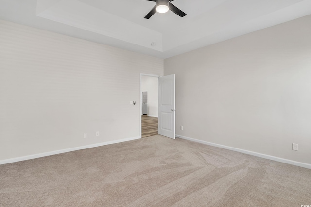 383 Hayloft Cir, Conway, SC 29526 - spare room with a raised ceiling, light carpet, a ceiling fan, and baseboards