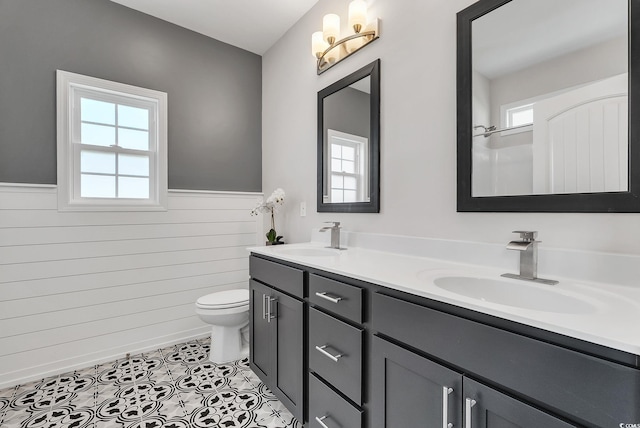 383 Hayloft Cir, Conway, SC 29526 - bathroom featuring wainscoting, plenty of natural light, toilet, double vanity, and tile patterned floors