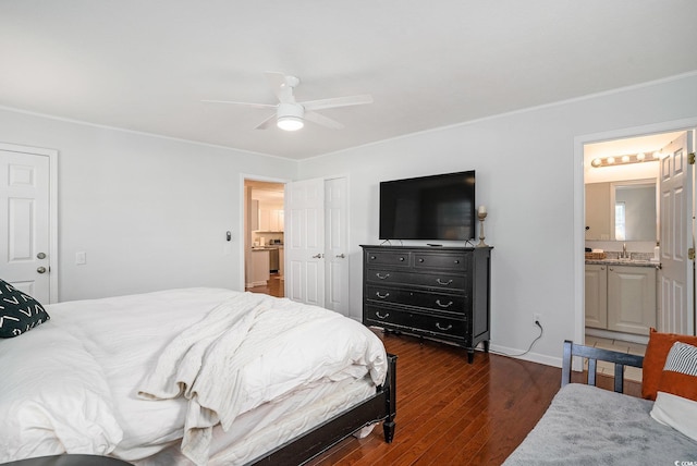 bedroom with wood finished floors, ornamental molding, baseboards, and a closet