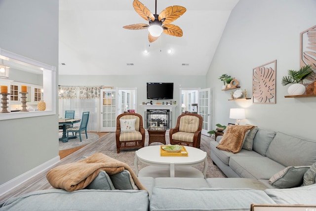 180 Waterhall Dr, Murrells Inlet, SC 29576 - living area featuring high vaulted ceiling, a ceiling fan, light wood-style flooring, baseboards, and a glass covered fireplace
