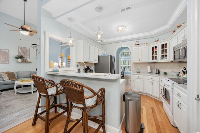 180 Waterhall Dr, Murrells Inlet, SC 29576 - kitchen featuring appliances with stainless steel finishes, a kitchen breakfast bar, glass insert cabinets, tasteful backsplash, and a ceiling fan