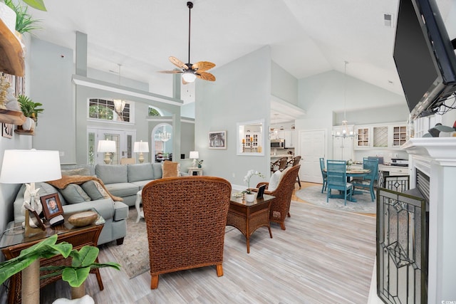 180 Waterhall Dr, Murrells Inlet, SC 29576 - living area with a ceiling fan, high vaulted ceiling, a chandelier, and light wood finished floors