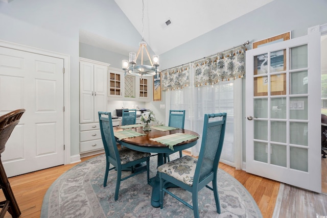 180 Waterhall Dr, Murrells Inlet, SC 29576 - dining room with a chandelier, high vaulted ceiling, and light wood-style flooring