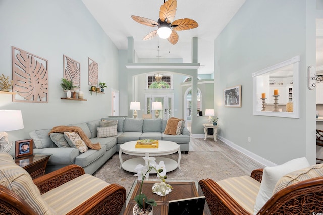 180 Waterhall Dr, Murrells Inlet, SC 29576 - living room with light wood-style floors, a ceiling fan, a towering ceiling, and baseboards