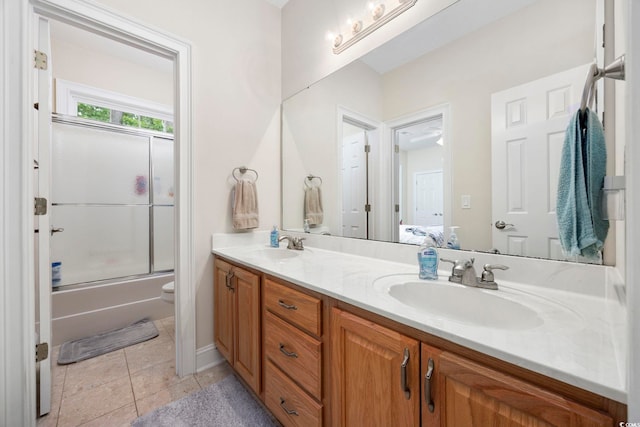 180 Waterhall Dr, Murrells Inlet, SC 29576 - bathroom with double vanity, tile patterned floors, toilet, and combined bath / shower with glass door
