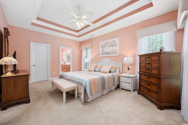180 Waterhall Dr, Murrells Inlet, SC 29576 - bedroom featuring a raised ceiling, light carpet, connected bathroom, and ceiling fan