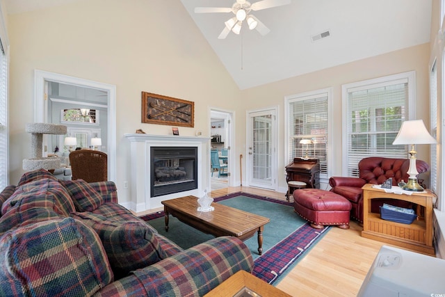 180 Waterhall Dr, Murrells Inlet, SC 29576 - living room with wood finished floors, high vaulted ceiling, a ceiling fan, a glass covered fireplace, and baseboards