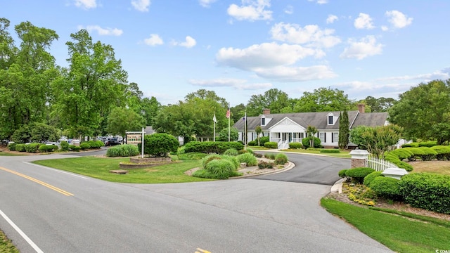 180 Waterhall Dr, Murrells Inlet, SC 29576 - view of front of home featuring driveway and view of scattered trees