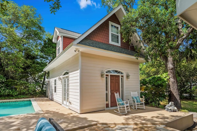 4003 N Ocean Blvd, Myrtle Beach, SC 29577 - back of house with roof with shingles, a patio, and an outdoor pool
