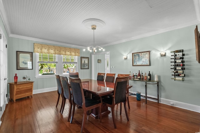 4003 N Ocean Blvd, Myrtle Beach, SC 29577 - dining room with an inviting chandelier, ornamental molding, dark wood-style flooring, and baseboards