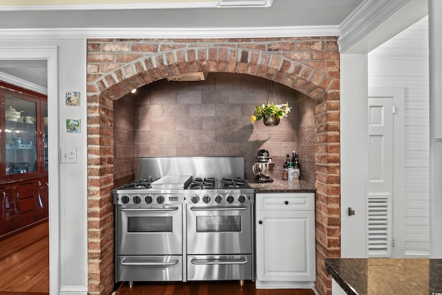 4003 N Ocean Blvd, Myrtle Beach, SC 29577 - kitchen with dark stone counters, visible vents, white cabinets, and double oven range