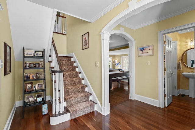 4003 N Ocean Blvd, Myrtle Beach, SC 29577 - staircase with wood finished floors, ornamental molding, ornate columns, arched walkways, and baseboards