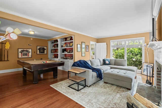 4003 N Ocean Blvd, Myrtle Beach, SC 29577 - living room with ornamental molding, a fireplace, pool table, and wood finished floors