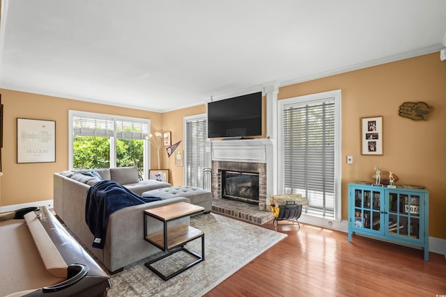 4003 N Ocean Blvd, Myrtle Beach, SC 29577 - living area featuring baseboards, a brick fireplace, crown molding, and wood finished floors