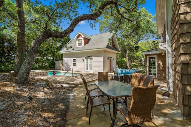 4003 N Ocean Blvd, Myrtle Beach, SC 29577 - view of patio featuring french doors, outdoor lounge area, an outdoor structure, an outdoor pool, and a storage structure