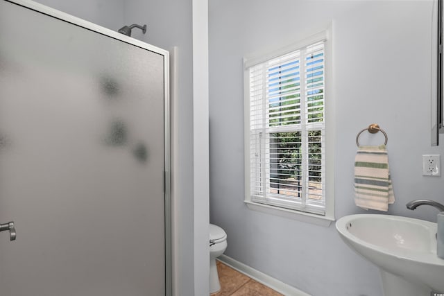 4003 N Ocean Blvd, Myrtle Beach, SC 29577 - bathroom featuring a sink, a stall shower, a healthy amount of sunlight, and tile patterned floors