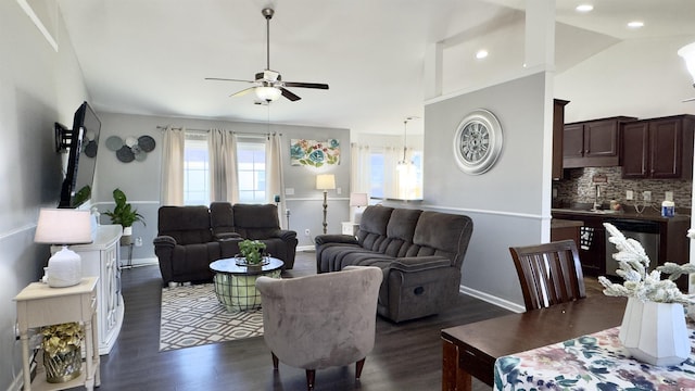 living room featuring a ceiling fan, dark wood-style floors, vaulted ceiling, and baseboards
