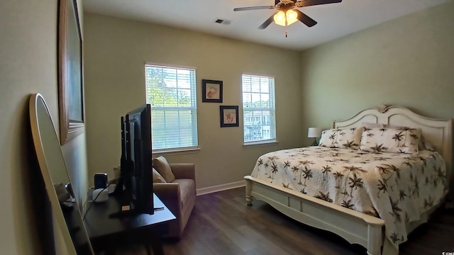 bedroom featuring dark wood finished floors, baseboards, and a ceiling fan