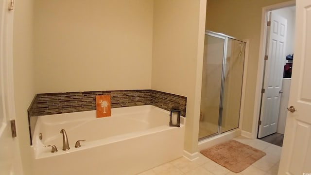 full bath with a stall shower, a bath, and tile patterned floors