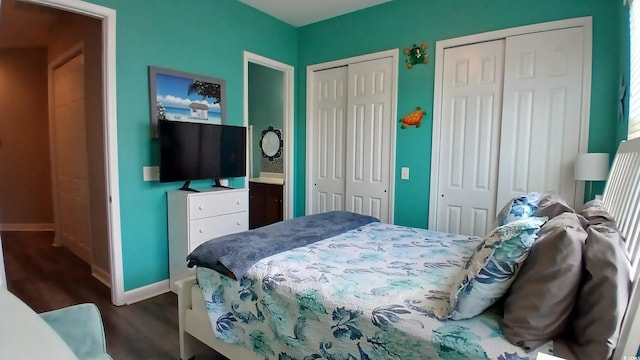 bedroom with multiple closets, baseboards, and dark wood finished floors