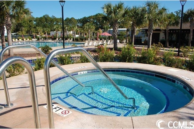 view of pool with a community hot tub